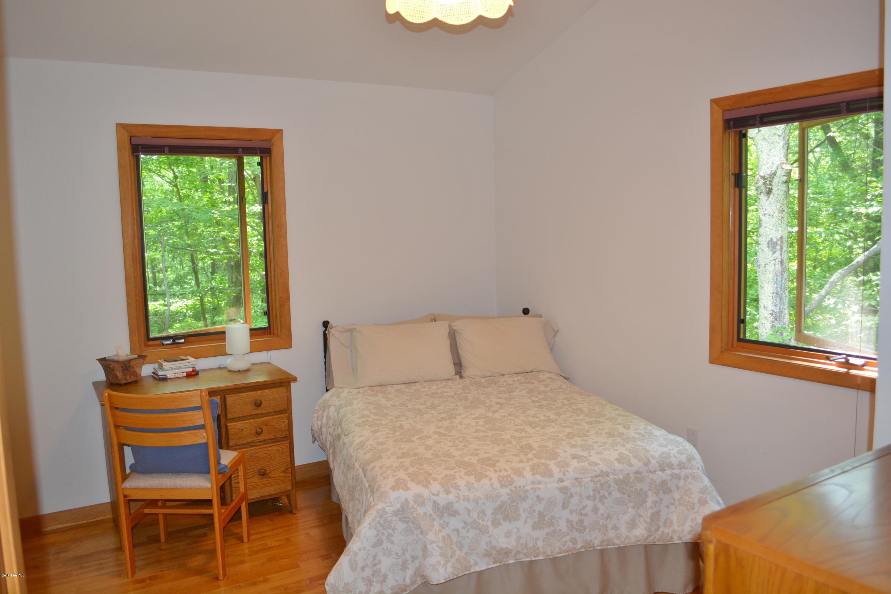 537 Norton Road Otis, MA 01029 - Photo 21 of 25 a bedroom with a bed and a window