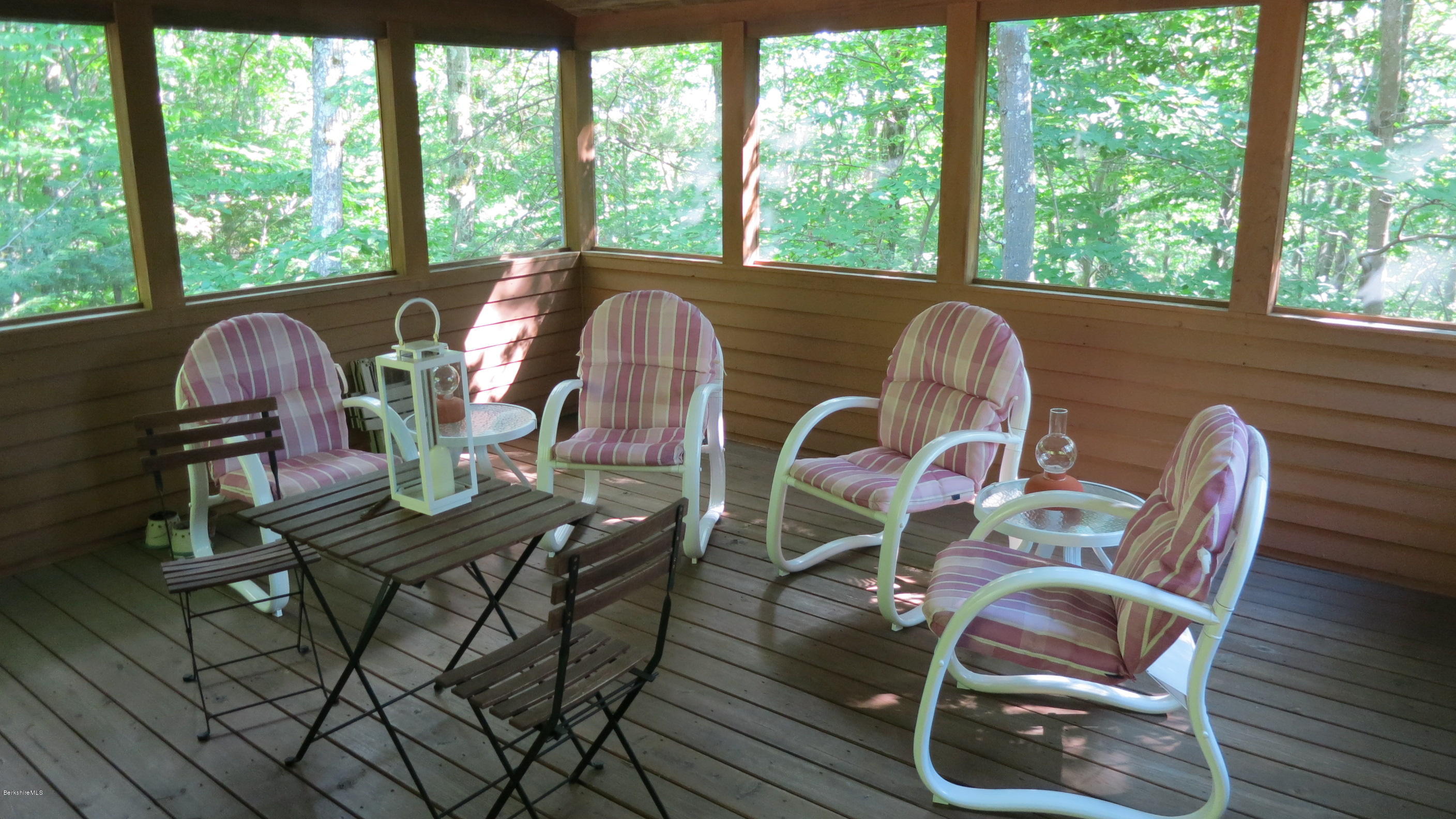 537 Norton Road Otis, MA 01029 - Photo 8 of 25 a view of a dining room with furniture wooden floor and windows