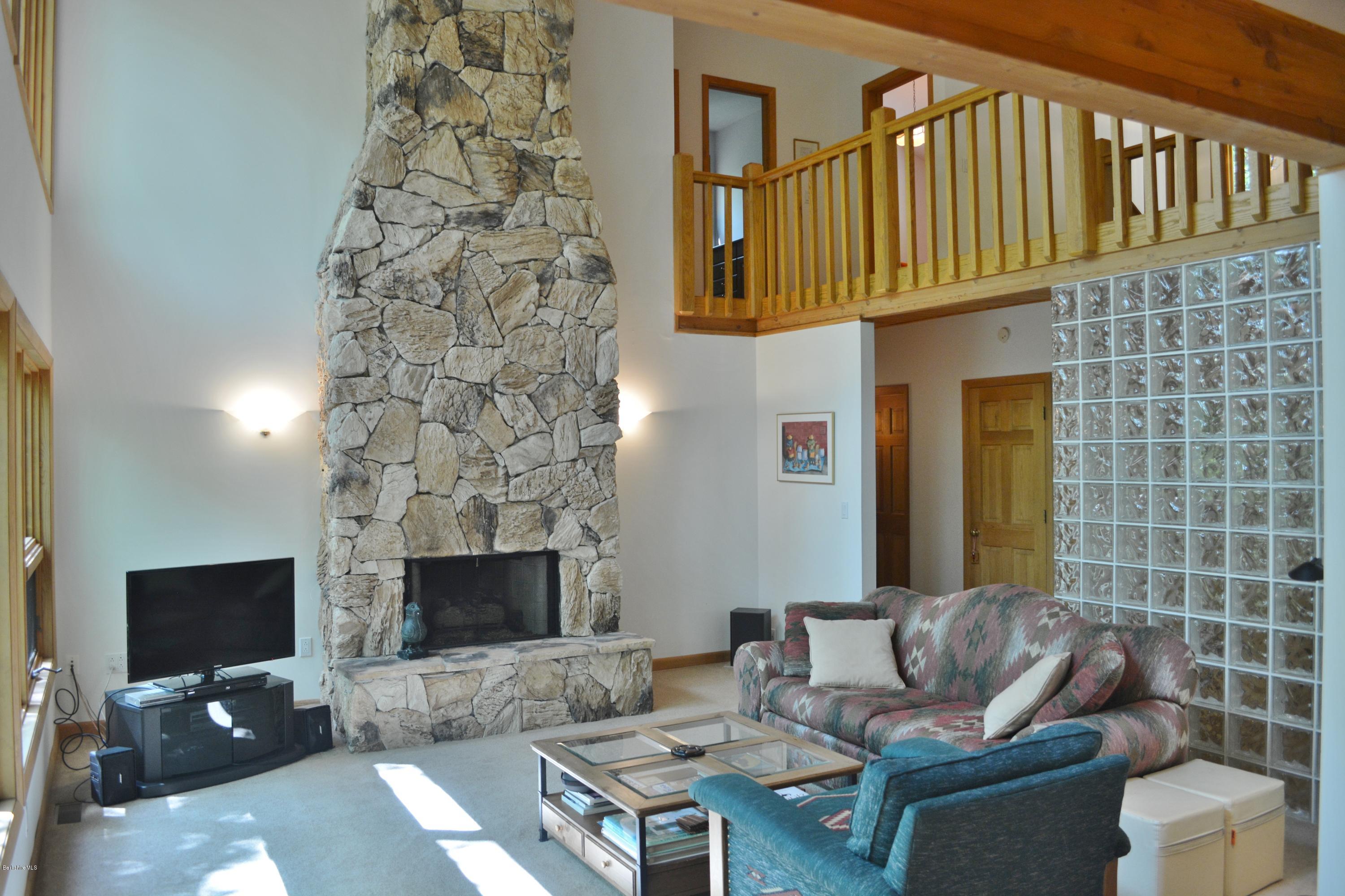 537 Norton Road Otis, MA 01029 - Photo 10 of 25 a living room with furniture and a fireplace