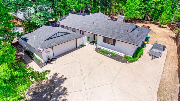 an aerial view of a house with a yard and potted plants