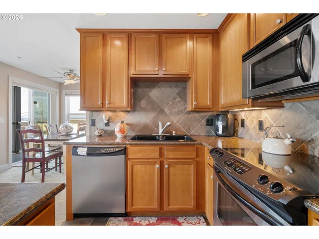 a living room with a couch and a view of kitchen