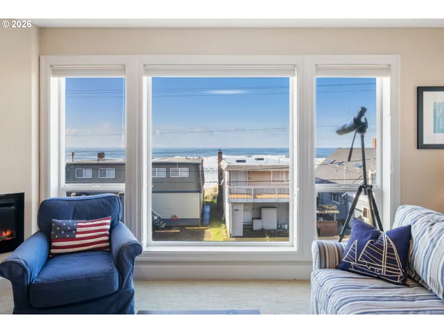 a living room with furniture and a floor to ceiling window