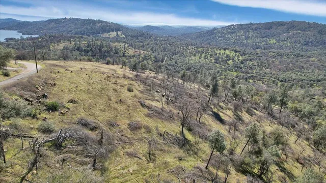 a view of a dry yard with mountains in the background