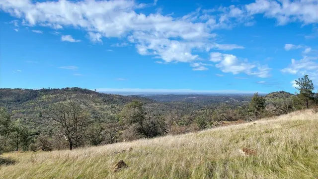 a view of a large building with a mountain in the background