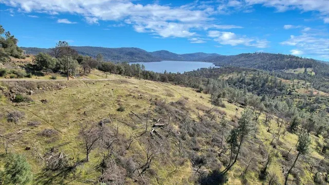 a view of a dry yard with mountains in the background