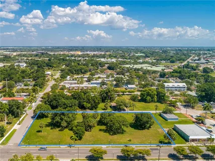 an aerial view of residential houses with outdoor space and ocean view