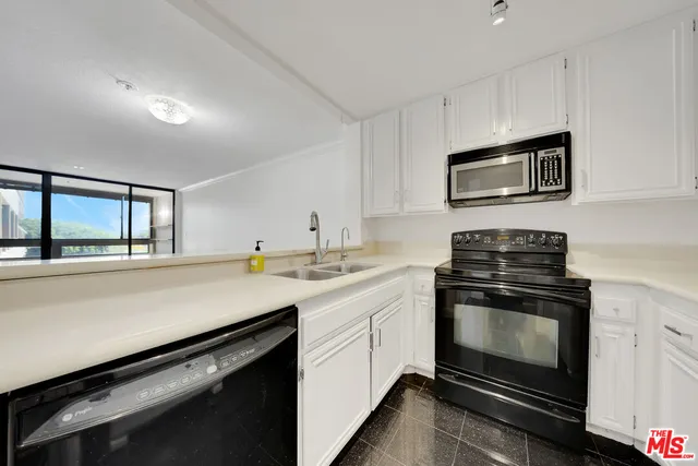 a kitchen with stainless steel appliances a stove sink and cabinets
