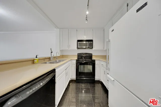 a kitchen with a sink and stainless steel appliances