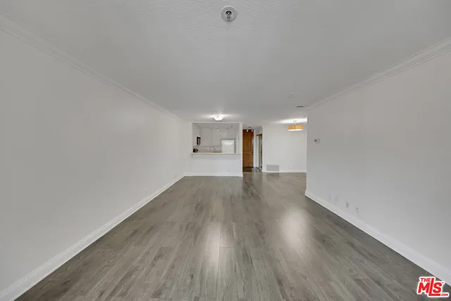 a view of a room with wooden floors and trees