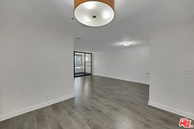 a view of a room with wooden floor