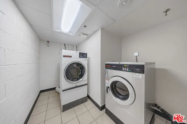 a utility room with sink dryer and washer