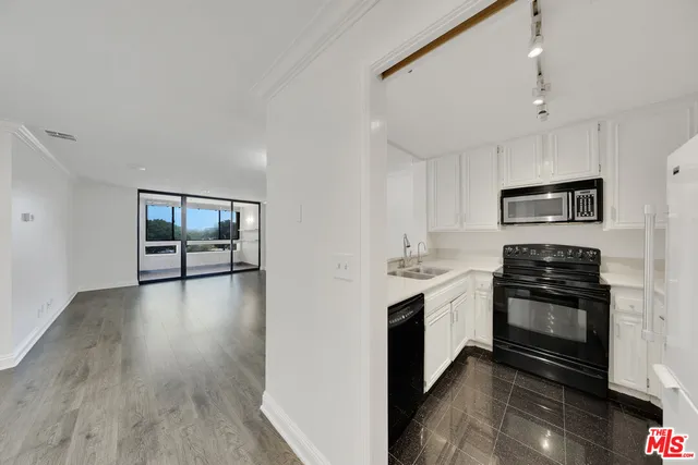 a kitchen with stainless steel appliances granite countertop a stove and a refrigerator