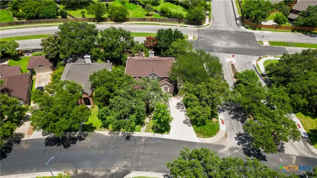 an aerial view of a house with a yard and garden