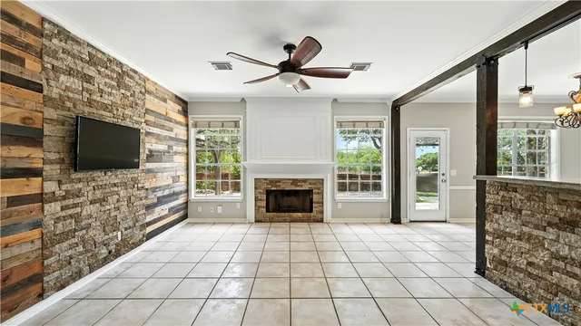 a living room with fireplace furniture and a flat screen tv