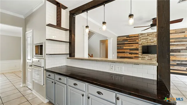 a kitchen with stainless steel appliances a sink and a refrigerator