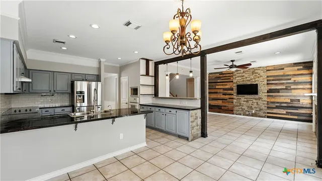 a kitchen with stainless steel appliances a sink and a refrigerator
