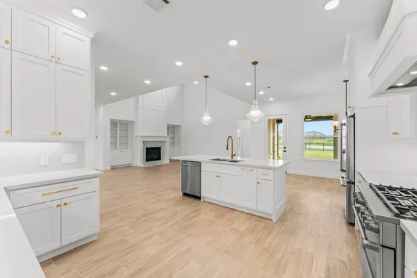a large kitchen with a large counter top appliances and cabinets