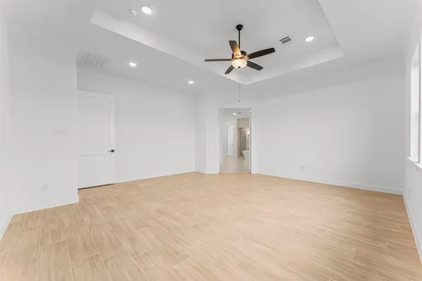 a view of an empty room with a ceiling fan