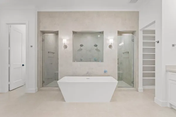a white bath tub sitting in a bathroom and a shower