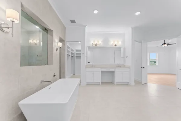 a bathroom with a tub sink shower and mirror