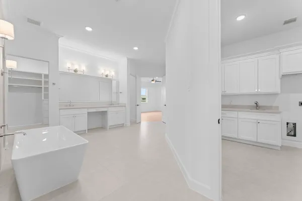 a view of a kitchen with white cabinets