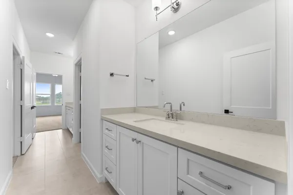 a spacious bathroom with a granite countertop sink mirror and double
