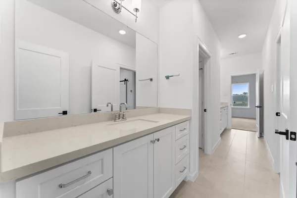 a spacious bathroom with a granite countertop sink mirror and double