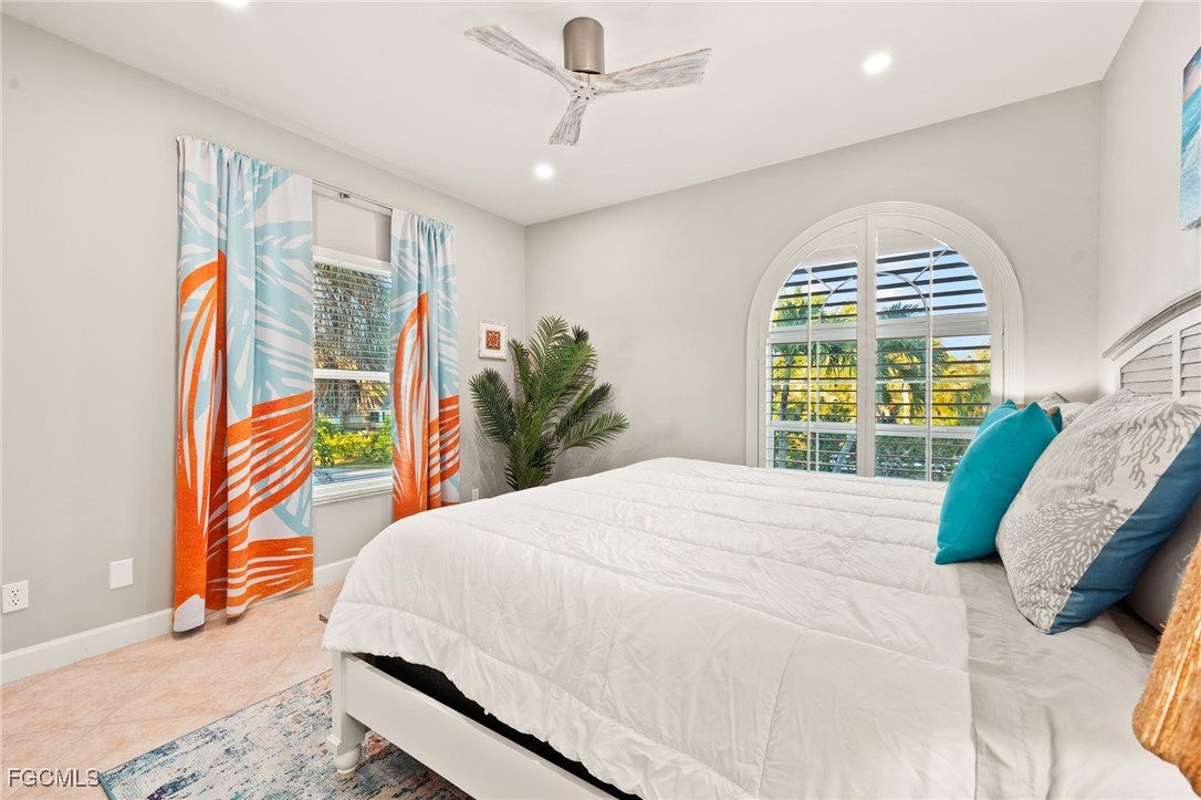 7507 Grande Pine Road Bokeelia, FL 33922 - Photo 24 of 46 a bedroom with a bed and a large window