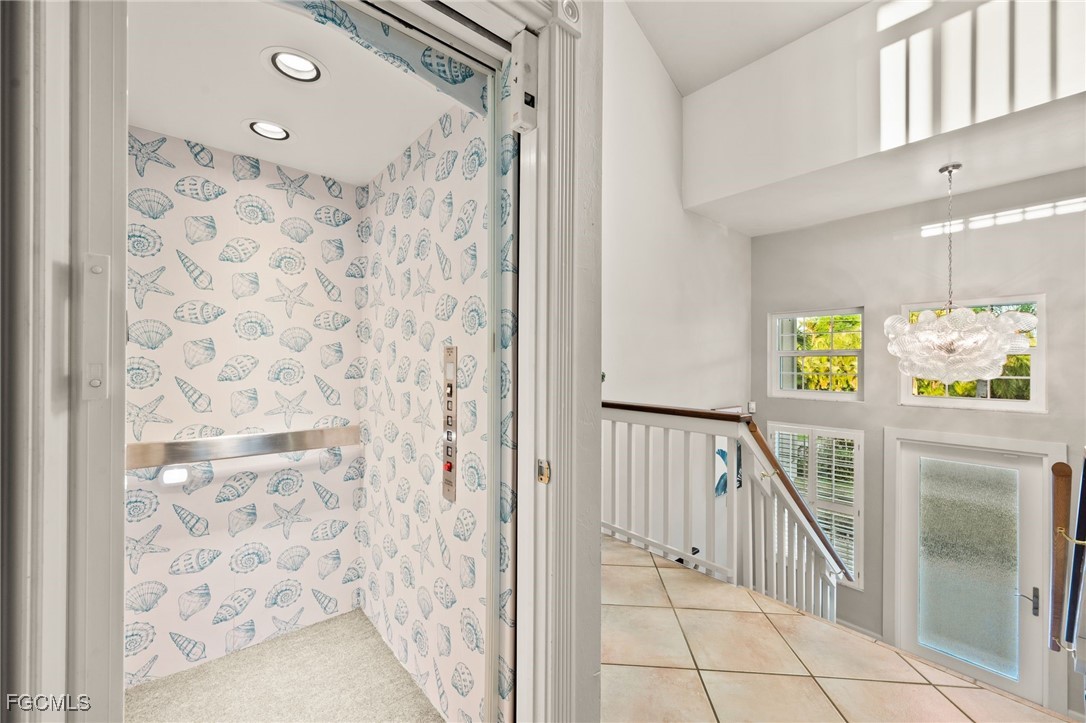 7507 Grande Pine Road Bokeelia, FL 33922 - Photo 9 of 46 a view of a hallway with wooden floor and staircase