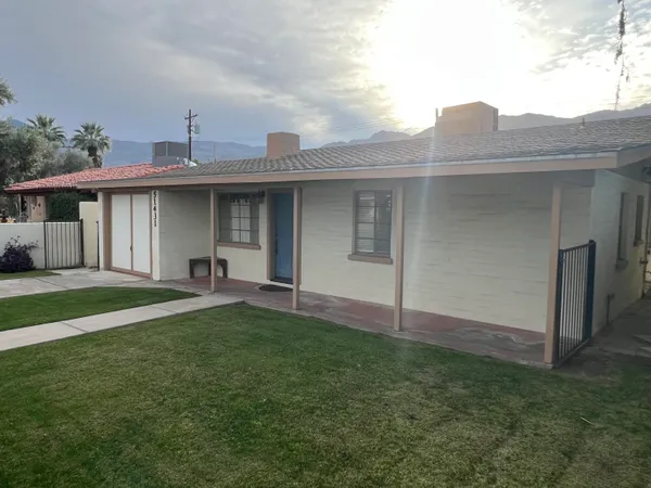 a view of a house with a yard and plants