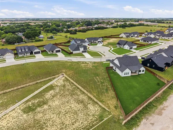 an aerial view of a residential houses with outdoor space and river