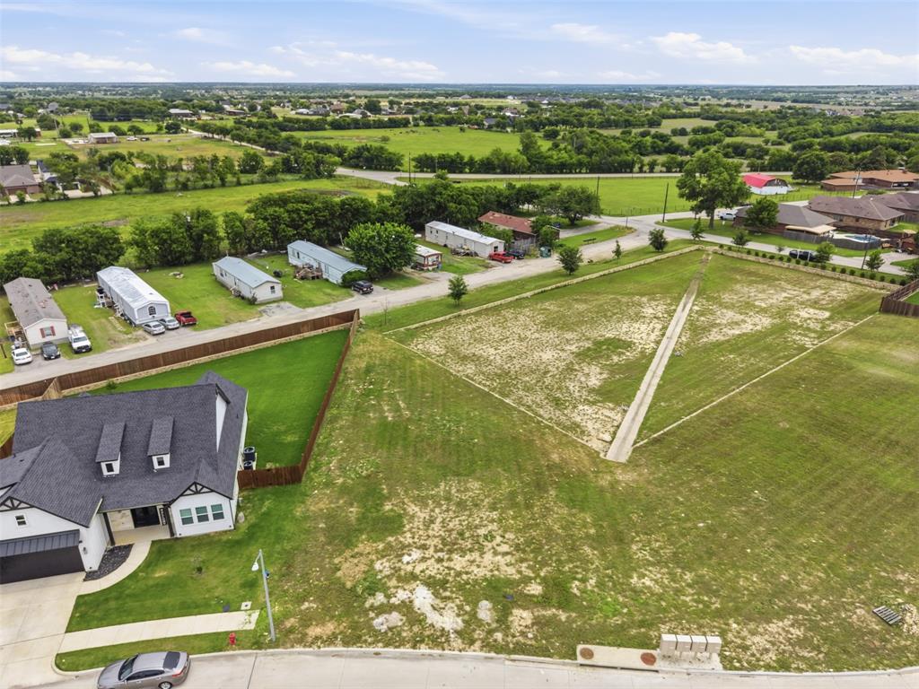 516 Highview Court Godley, TX 76044 - Photo 6 of 15 a view of a swimming pool with a patio and a garden