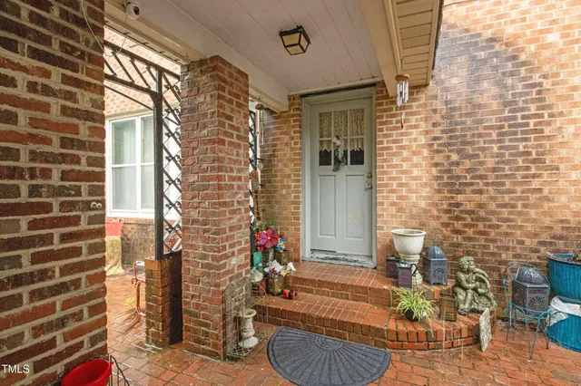 a living room with furniture a table and a large window