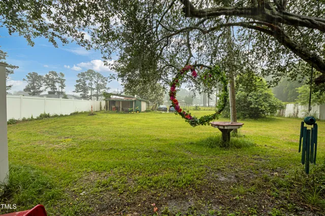 a front view of a house with a big yard