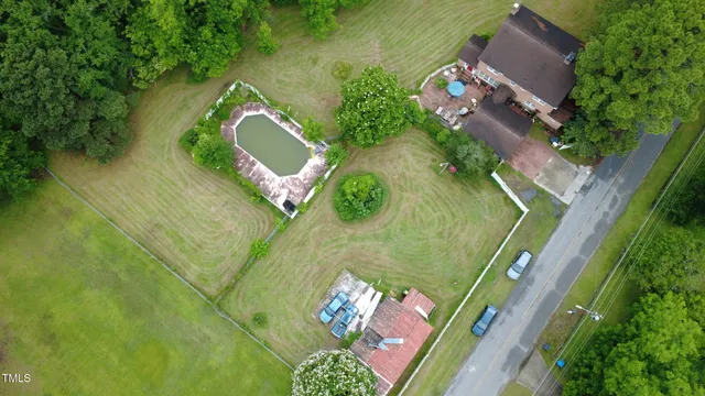 an aerial view of a house with a yard and lake view