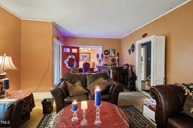 a view of a house with a yard and a large tree