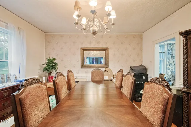 a living room with furniture a large window and a fireplace