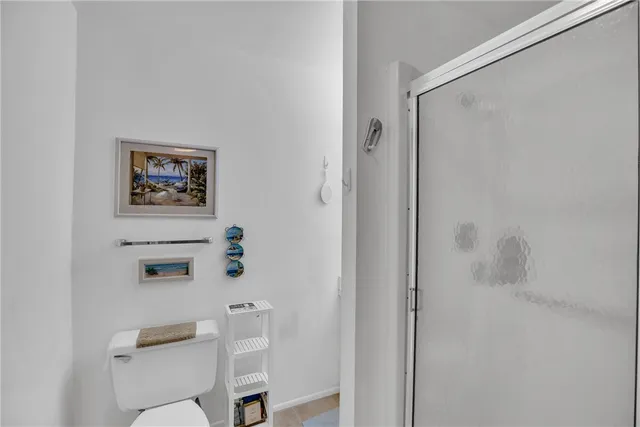 a bathroom with a toilet and a shower