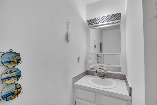 a bathroom with a sink vanity and a mirror