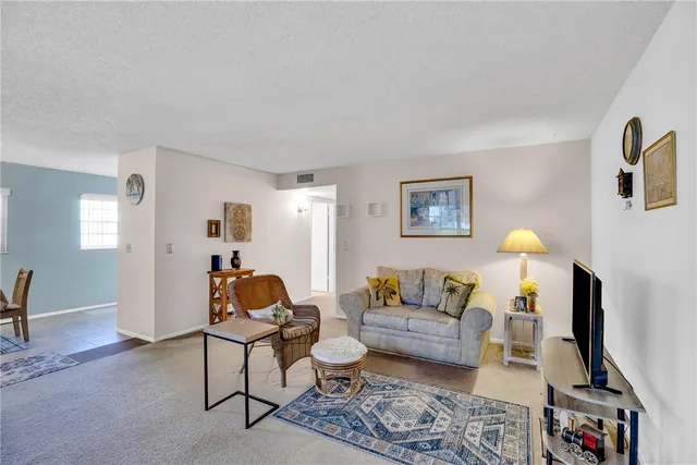 a living room with furniture and a lamp
