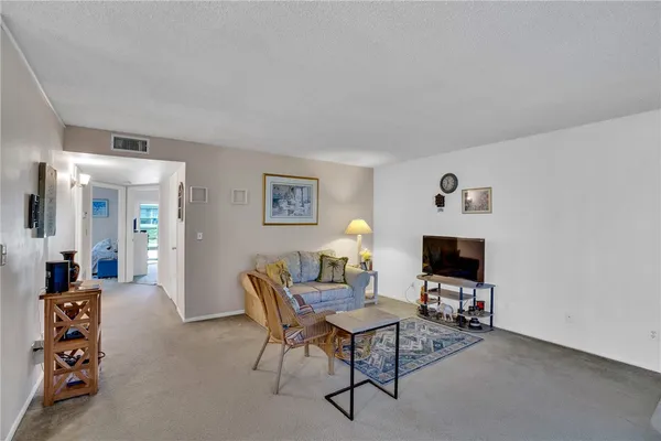 a view of a livingroom with furniture and a flat screen tv