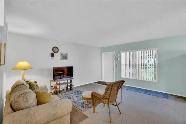 a living room with furniture a table and a lamp