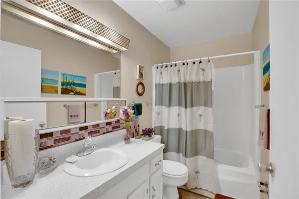 a bathroom with a sink toilet tub and shower