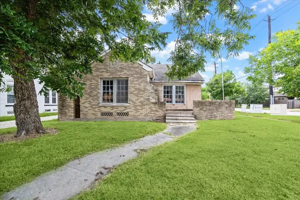 a view of backyard of house with green space