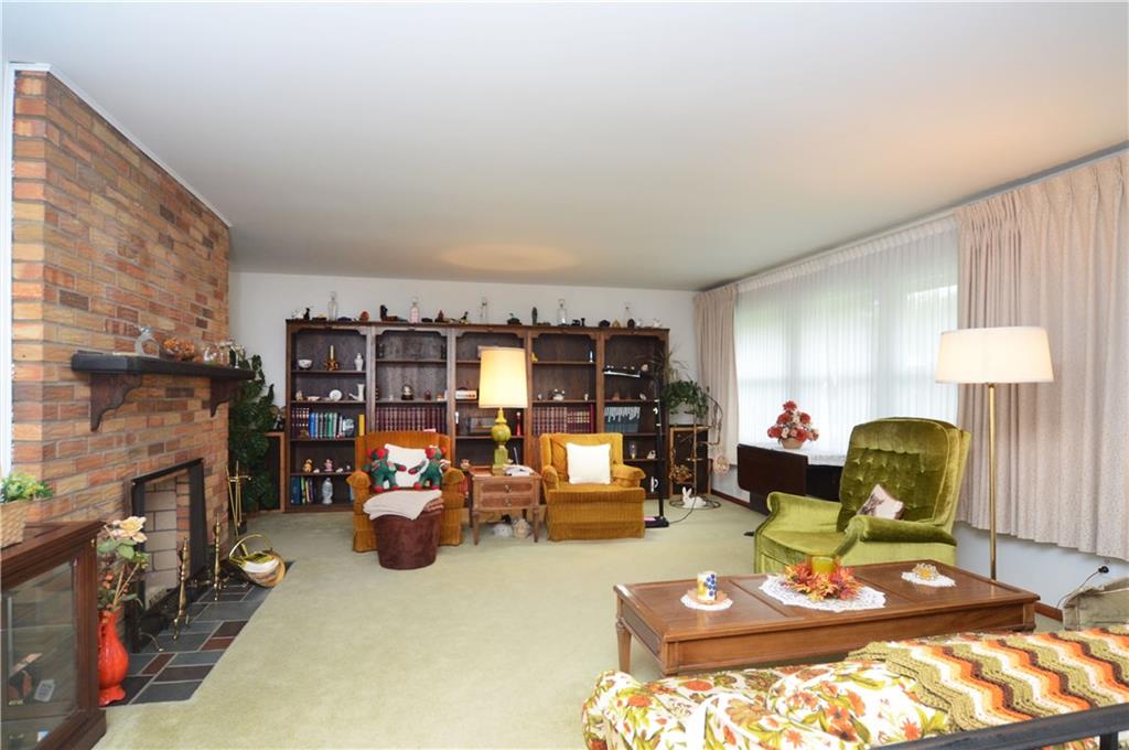 207 Lytton Road Coraopolis, PA 15108 - Photo 2 of 17 a living room with furniture a fireplace and a table