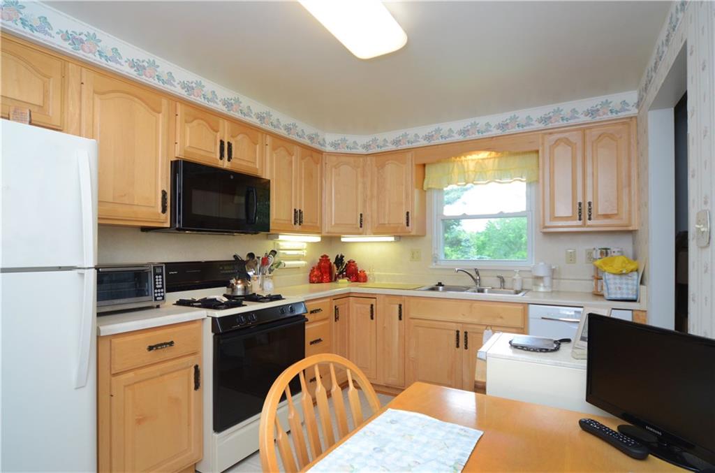 207 Lytton Road Coraopolis, PA 15108 - Photo 3 of 17 a kitchen with stainless steel appliances a stove a sink a microwave a refrigerator and cabinets