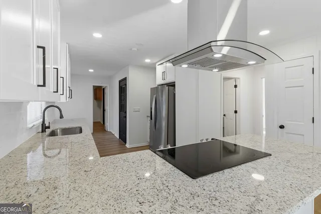 a bathroom with a granite countertop sink a large mirror and shower