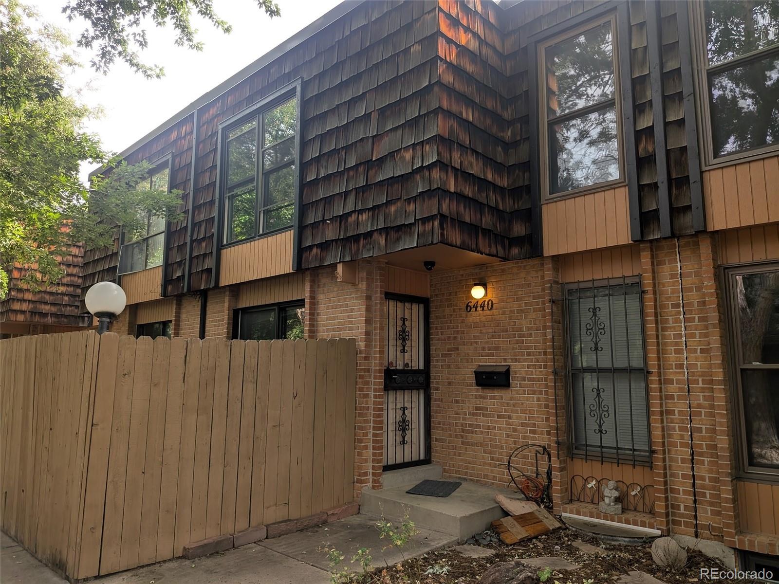 6440 Wright Street Arvada, CO 80004 - Photo 1 of 15 a front view of a building with a street
