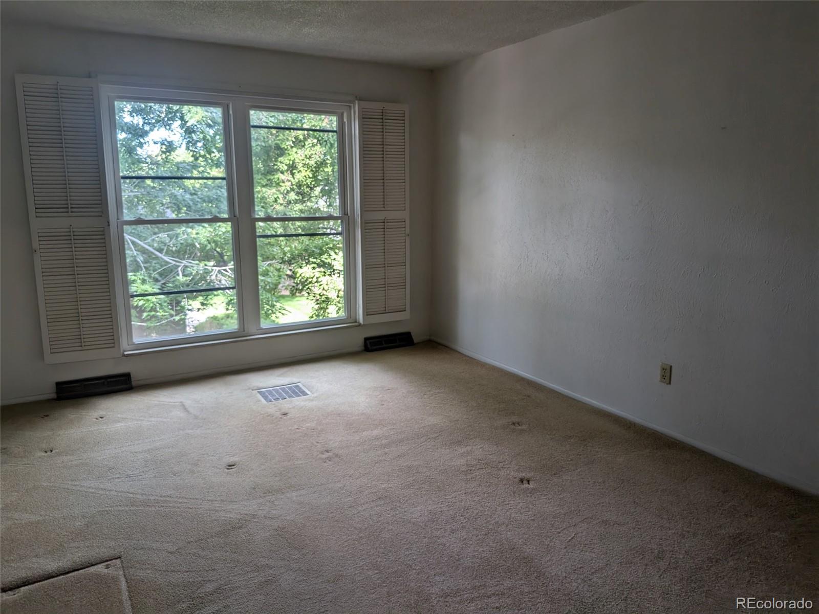 6440 Wright Street Arvada, CO 80004 - Photo 9 of 15 a view of an empty room with a window