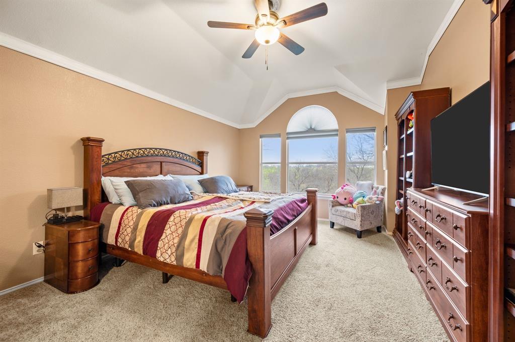 4008 Falcon Ridge Drive Haltom City, TX 76137 - Photo 20 of 32 a bed room with a bed and a chandelier